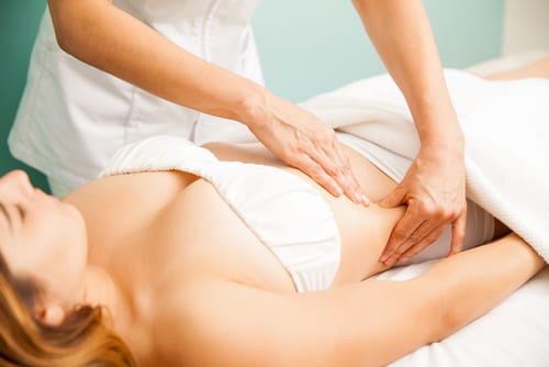 Beautiful young woman getting a lymphatic massage at a health and beauty spa-img-blog