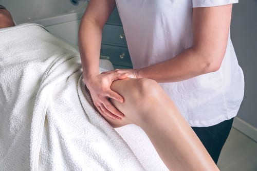 Massage therapist hands doing lymphatic drainage treatment to woman-img-blog