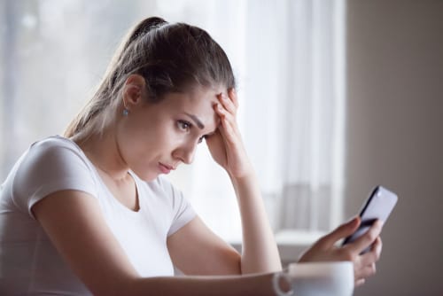 angry young woman looking at smartphone frustrated -img-blog
