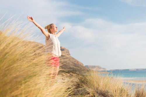 woman, arms rised, enjoying sun, freedom and life an a beautiful beach-img-blog