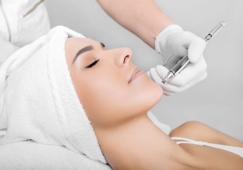 face of beautiful woman while procedure jet peeling, facial treatment-img-blog