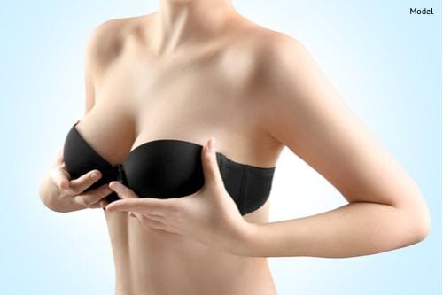 woman-enjoys-the-natural,-perky-shape-of-her-breasts-that-can-be-achieved-with-breast-lift-surgery-img-blog-compressor