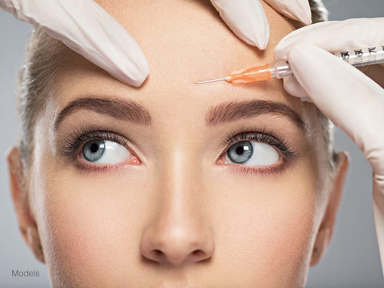 A woman demonstrating an injectable filler procedure to get rid of fine lines and wrinkles.