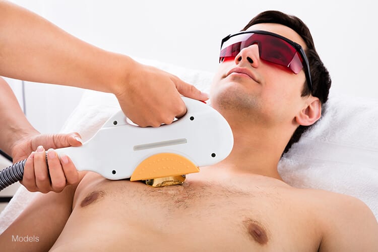 A young man receives a laser hair removal treatment on his chest. Laser hair removal can be a safe and effective way for men to get rid of unwanted hair along the body and face.