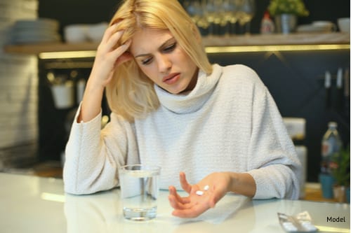 Woman preparing to take pills after surgery-img-blog