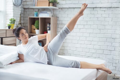 Asian women exercising in bed