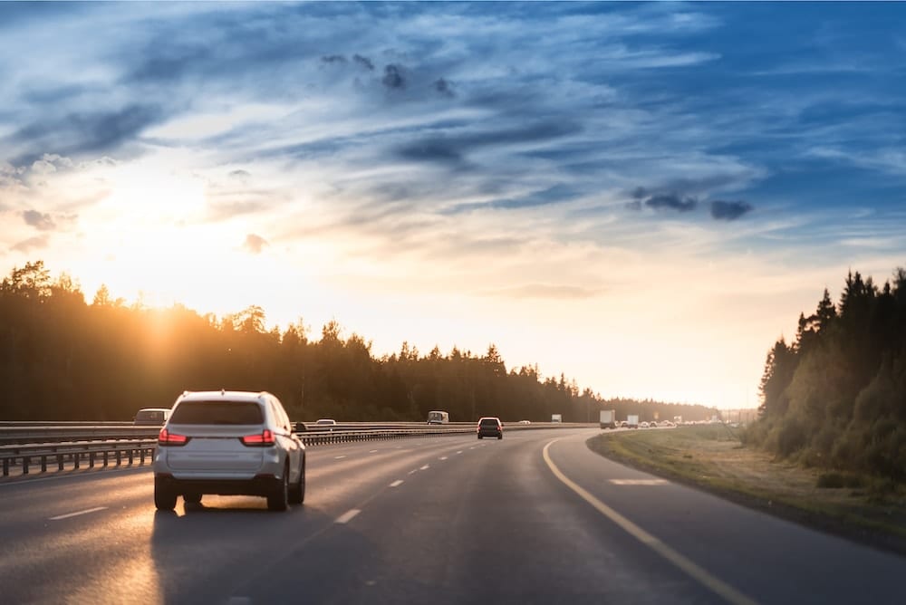 Cars driving out of town on the highway.