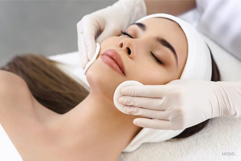 Woman getting a skin exfoliation facial.