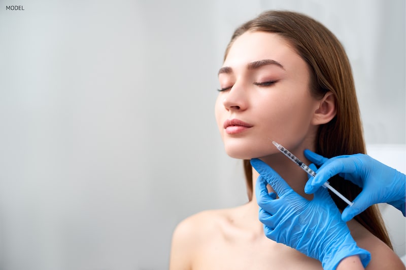 Woman receiving an injection to treat her marionette lines.