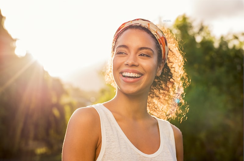 Woman standing outside in the sun