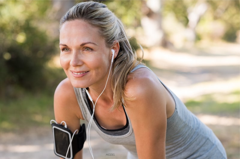 Middle aged woman resting during her exercise routine.