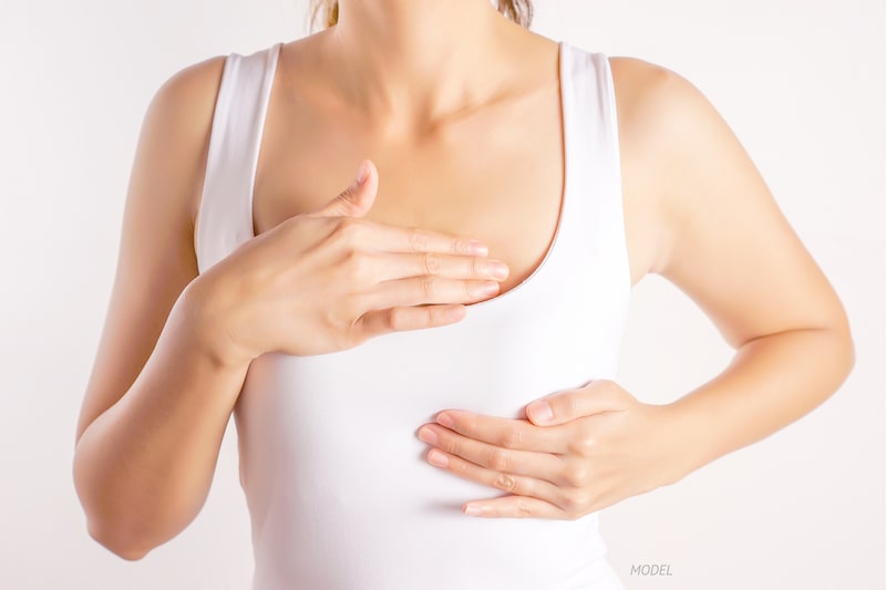 Woman massaging her breast.