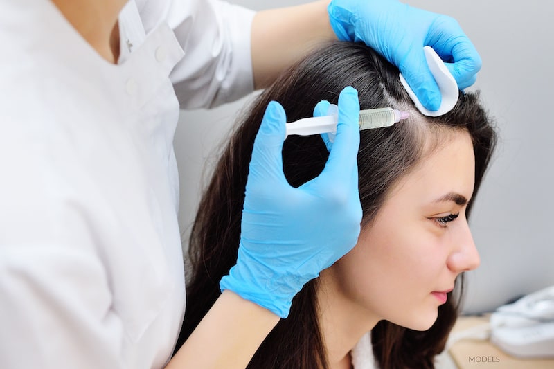 woman having PRP injected into her scalp.