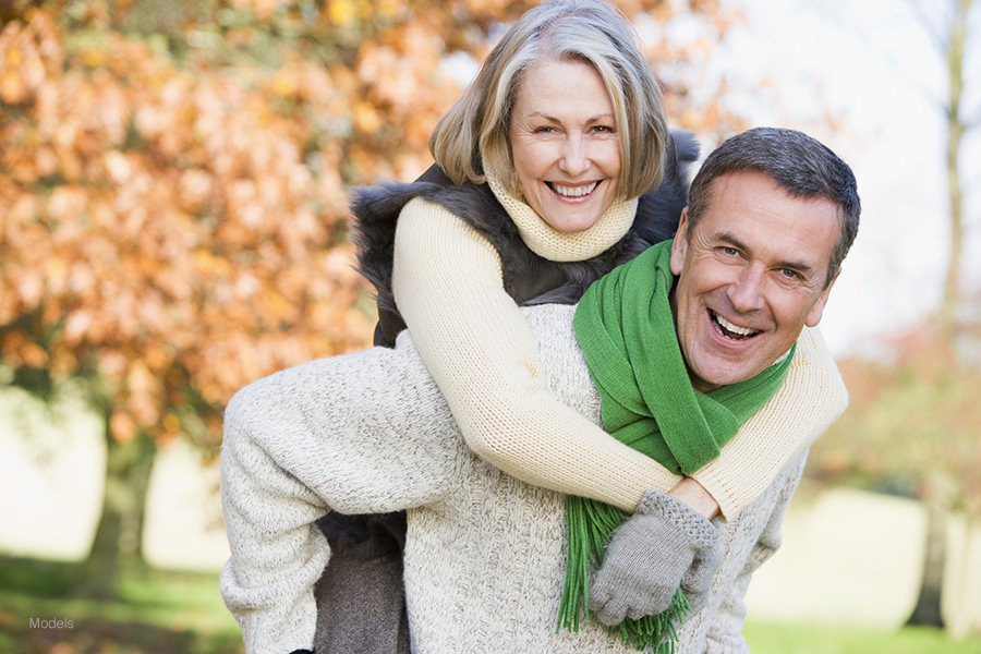 A healthy and fit older couple enjoys an autumn day outside.