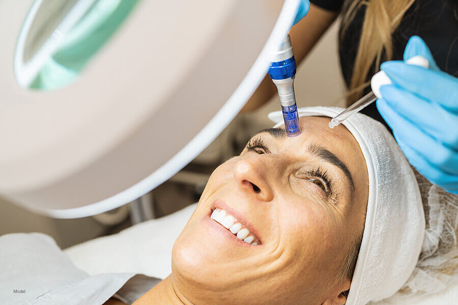 A woman receives PRP with microneedling treatment.