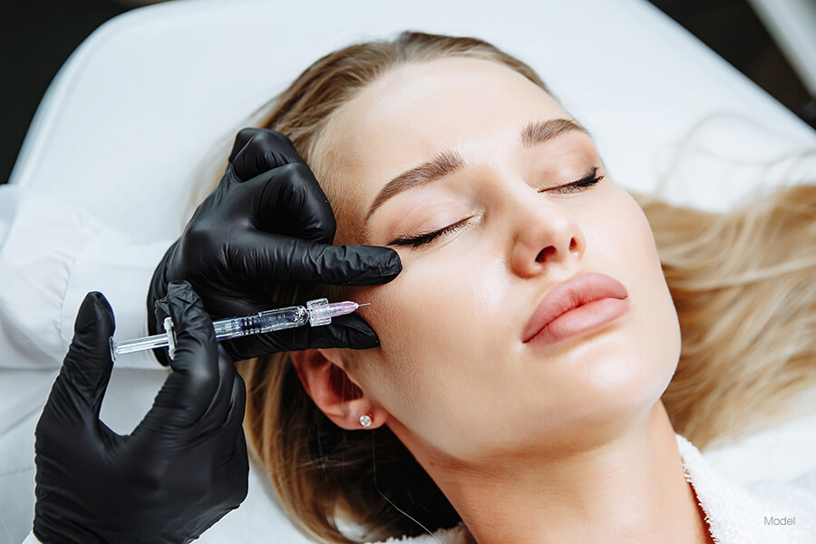 A beautiful woman receives an injectable facial filler.