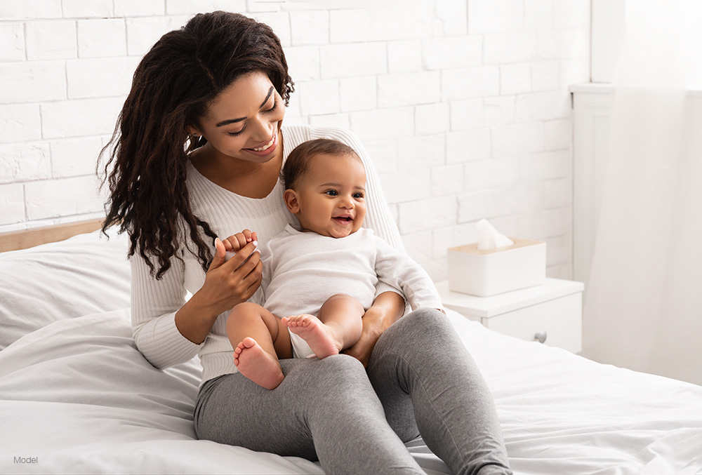 Woman and child sitting on a bed
